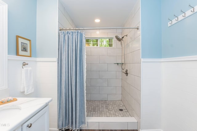 10 Biltmore Pl, Durham, NC 27712 - bathroom with a tile shower, vanity, wainscoting, tile walls, and recessed lighting