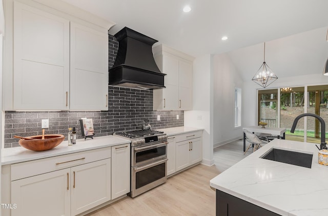 3714 Ode Turner Rd, Hillsborough, NC 27278 - kitchen with range with two ovens, custom exhaust hood, tasteful backsplash, a chandelier, and light wood finished floors