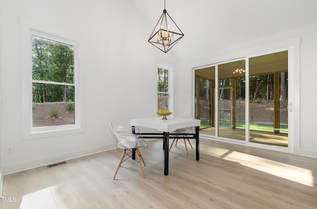 3714 Ode Turner Rd, Hillsborough, NC 27278 - dining space featuring a chandelier, healthy amount of natural light, light wood-style floors, and vaulted ceiling