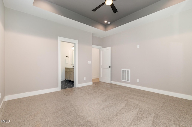 3714 Ode Turner Rd, Hillsborough, NC 27278 - unfurnished bedroom with carpet floors, a raised ceiling, connected bathroom, and a ceiling fan