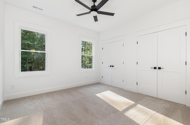 3714 Ode Turner Rd, Hillsborough, NC 27278 - unfurnished bedroom with multiple closets, light carpet, and ceiling fan