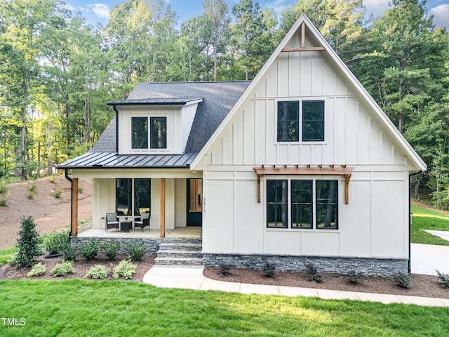 3714 Ode Turner Rd, Hillsborough, NC 27278 - modern inspired farmhouse with board and batten siding, a porch, a standing seam roof, and a front yard