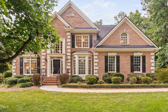 100 Beraneak Ln, Cary, NC 27519 - view of front of property with brick siding, a front lawn, and roof with shingles