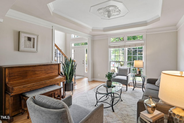 100 Beraneak Ln, Cary, NC 27519 - living area with plenty of natural light, a raised ceiling, light wood-style floors, crown molding, and stairs