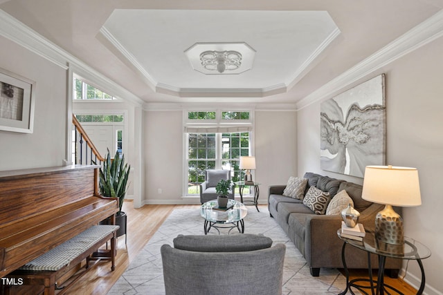 100 Beraneak Ln, Cary, NC 27519 - living area featuring a raised ceiling, plenty of natural light, light wood-type flooring, ornamental molding, and stairs