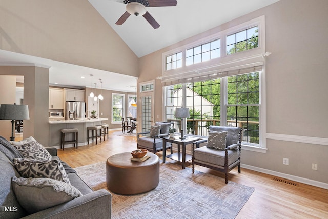 100 Beraneak Ln, Cary, NC 27519 - living area featuring plenty of natural light, a ceiling fan, high vaulted ceiling, and light wood finished floors