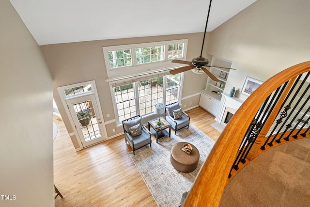 100 Beraneak Ln, Cary, NC 27519 - living room with a ceiling fan, high vaulted ceiling, wood finished floors, and a fireplace with flush hearth