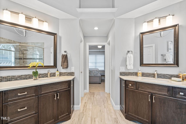 100 Beraneak Ln, Cary, NC 27519 - full bathroom with a stall shower, two vanities, connected bathroom, wood finished floors, and crown molding