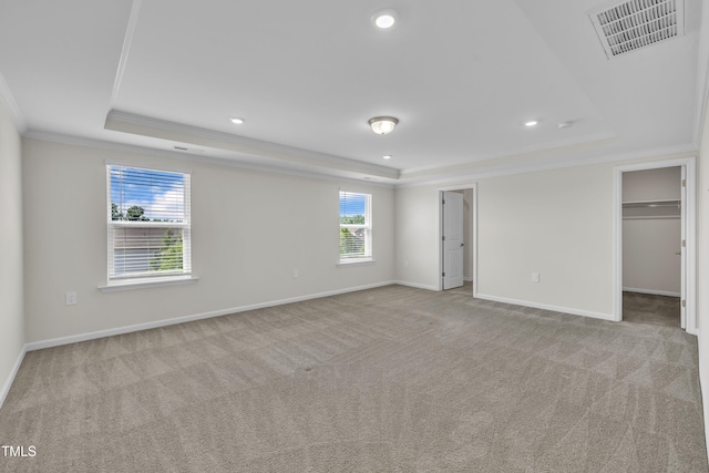 2307 Bethpage Dr, Fuquay Varina, NC 27526 - unfurnished bedroom with a tray ceiling, ornamental molding, carpet floors, a walk in closet, and recessed lighting