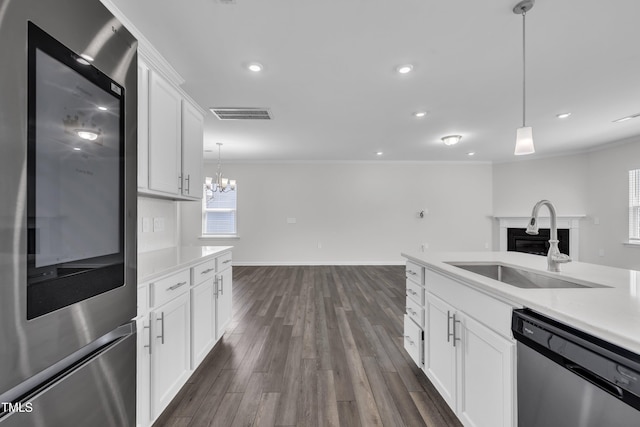 2307 Bethpage Dr, Fuquay Varina, NC 27526 - kitchen featuring smart refrigerator, stainless steel dishwasher, a fireplace, crown molding, and hanging light fixtures