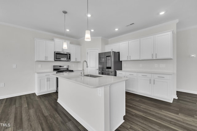 2307 Bethpage Dr, Fuquay Varina, NC 27526 - kitchen with appliances with stainless steel finishes, white cabinetry, tasteful backsplash, crown molding, and a center island with sink