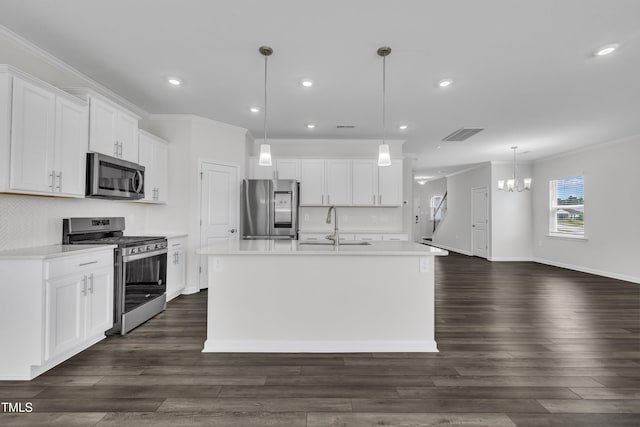 2307 Bethpage Dr, Fuquay Varina, NC 27526 - kitchen with appliances with stainless steel finishes, crown molding, a chandelier, a center island with sink, and light countertops