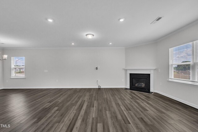 2307 Bethpage Dr, Fuquay Varina, NC 27526 - unfurnished living room with crown molding, dark wood-type flooring, a fireplace with flush hearth, recessed lighting, and a chandelier