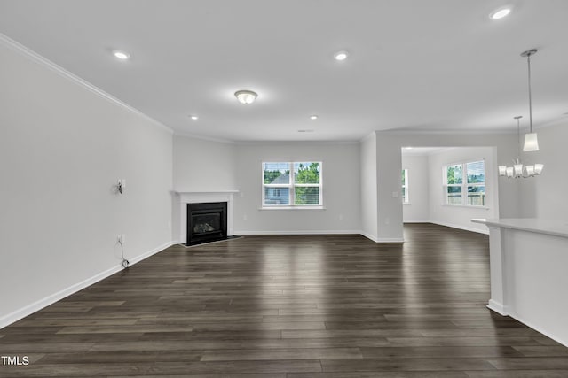 2307 Bethpage Dr, Fuquay Varina, NC 27526 - unfurnished living room with ornamental molding, plenty of natural light, a glass covered fireplace, dark wood-style flooring, and recessed lighting