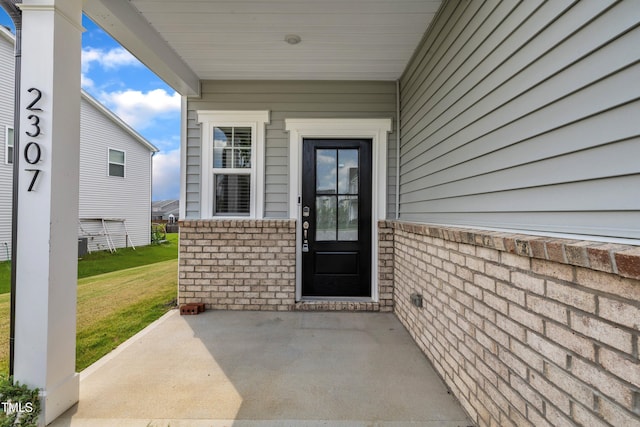 2307 Bethpage Dr, Fuquay Varina, NC 27526 - entrance to property featuring brick siding, a patio area, and a lawn