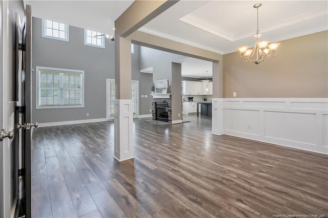 117 Kodiak Cir, Raeford, NC 28376 - entrance foyer featuring a chandelier, dark wood-type flooring, crown molding, a tray ceiling, and a high ceiling
