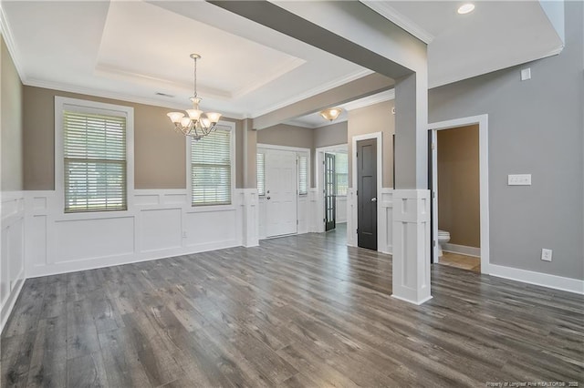 117 Kodiak Cir, Raeford, NC 28376 - unfurnished dining area with a chandelier, dark wood-style flooring, a raised ceiling, crown molding, and wainscoting