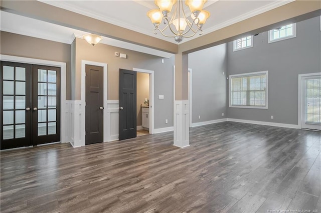 117 Kodiak Cir, Raeford, NC 28376 - unfurnished living room with ornamental molding, french doors, a chandelier, and dark wood finished floors