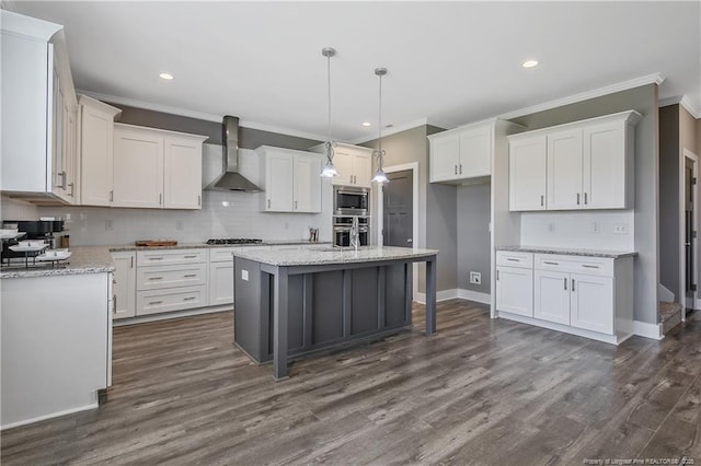 117 Kodiak Cir, Raeford, NC 28376 - kitchen with wall chimney range hood, ornamental molding, appliances with stainless steel finishes, white cabinets, and decorative backsplash