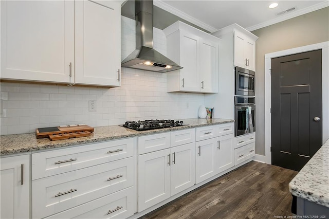 117 Kodiak Cir, Raeford, NC 28376 - kitchen featuring wall chimney exhaust hood, stainless steel appliances, crown molding, white cabinetry, and dark wood finished floors