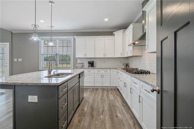 117 Kodiak Cir, Raeford, NC 28376 - kitchen featuring appliances with stainless steel finishes, crown molding, wall chimney exhaust hood, white cabinets, and wood finished floors