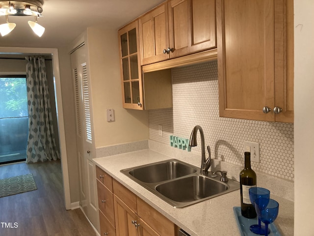 3082 Colony Rd Unit A, Durham, NC 27705 - kitchen with tasteful backsplash, light countertops, dark wood-type flooring, glass insert cabinets, and brown cabinets