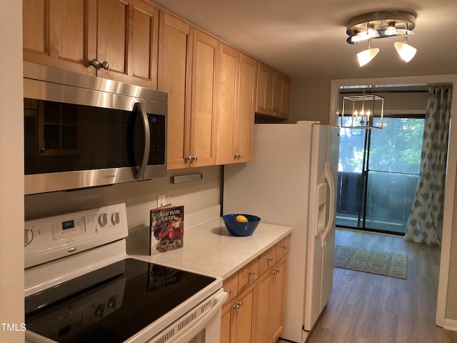 3082 Colony Rd Unit A, Durham, NC 27705 - kitchen with white appliances, wood finished floors, light countertops, and a chandelier