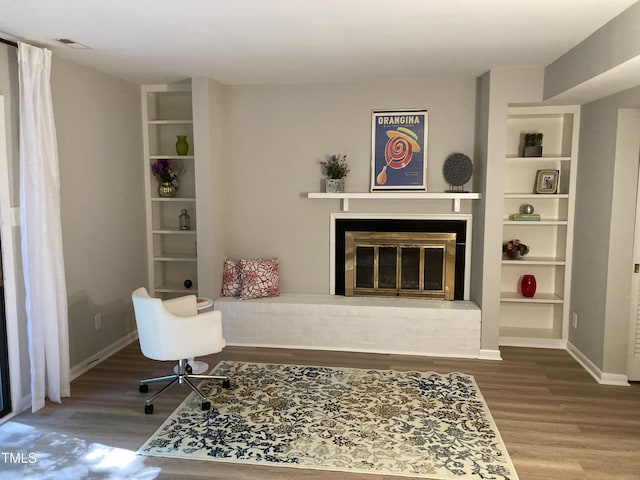 3082 Colony Rd Unit A, Durham, NC 27705 - living room with wood finished floors, built in features, and a brick fireplace