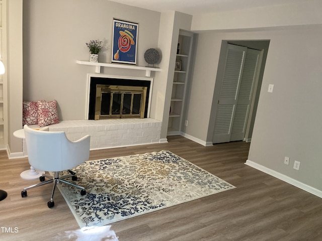 3082 Colony Rd Unit A, Durham, NC 27705 - living area featuring wood finished floors, a brick fireplace, and built in shelves