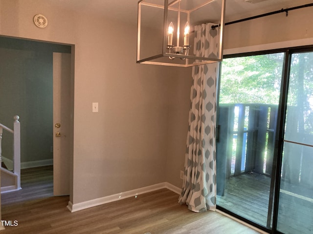3082 Colony Rd Unit A, Durham, NC 27705 - unfurnished dining area featuring a chandelier and wood finished floors