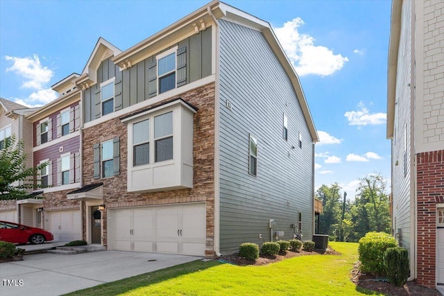 1035 Brownsmith Dr, Apex, NC 27502 - view of front of property featuring board and batten siding, a garage, concrete driveway, stone siding, and a front yard