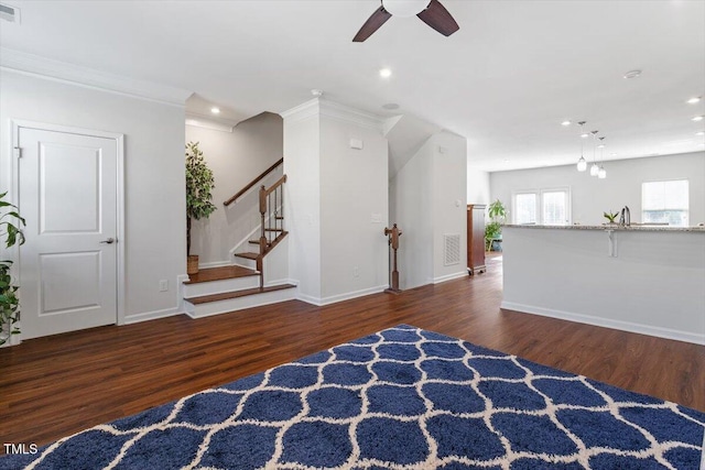 1035 Brownsmith Dr, Apex, NC 27502 - living area with wood finished floors, ceiling fan, recessed lighting, stairway, and crown molding