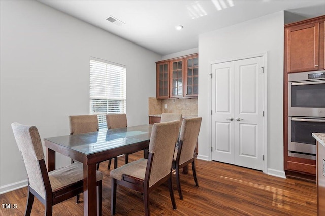 1035 Brownsmith Dr, Apex, NC 27502 - dining space with dark wood finished floors and baseboards