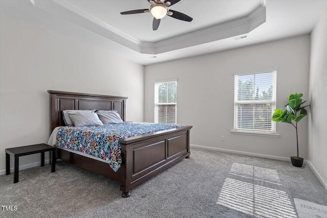 1035 Brownsmith Dr, Apex, NC 27502 - bedroom with ornamental molding, a tray ceiling, light carpet, and a ceiling fan