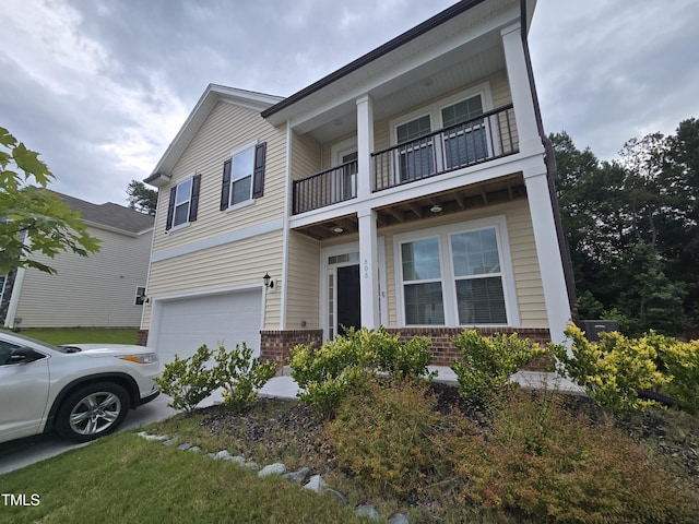 808 Heartpine Dr, Mebane, NC 27302 - view of front facade with a balcony, brick siding, a garage, and driveway