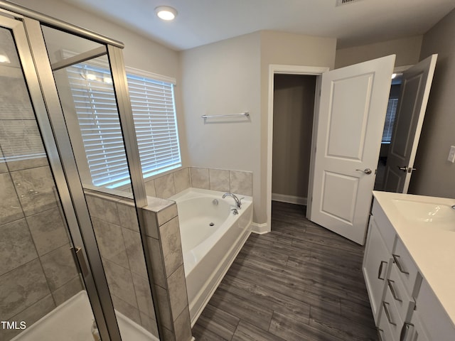808 Heartpine Dr, Mebane, NC 27302 - bathroom featuring a garden tub, a stall shower, vanity, and wood finished floors