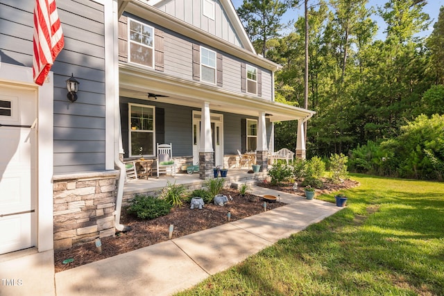 121 Roundrock Ln, Sanford, NC 27330 - view of front of home featuring a porch, a front lawn, board and batten siding, and stone siding