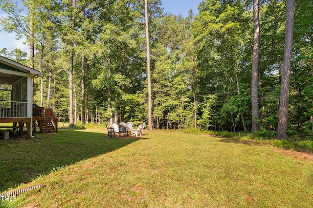 121 Roundrock Ln, Sanford, NC 27330 - view of green lawn featuring stairs, a sunroom, and a wooden deck