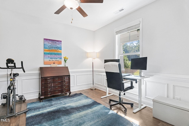121 Roundrock Ln, Sanford, NC 27330 - home office featuring a ceiling fan, a decorative wall, a wainscoted wall, and wood finished floors