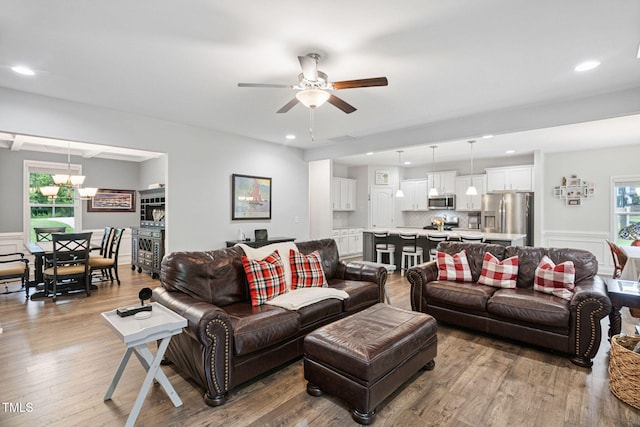 121 Roundrock Ln, Sanford, NC 27330 - living room featuring a ceiling fan, wood finished floors, recessed lighting, a wainscoted wall, and a chandelier