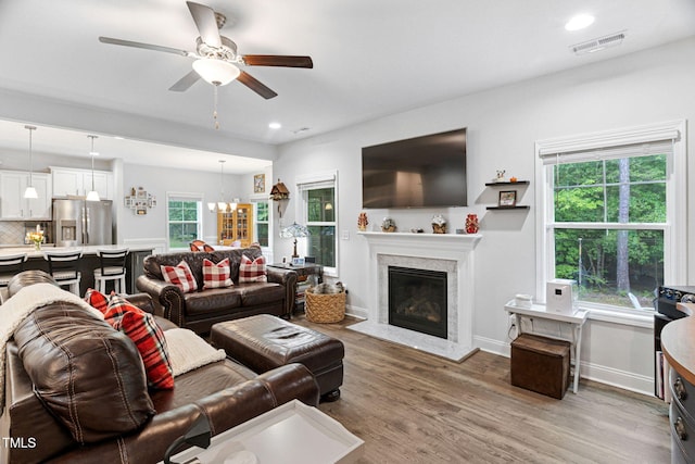 121 Roundrock Ln, Sanford, NC 27330 - living area with light wood-type flooring, ceiling fan, a high end fireplace, recessed lighting, and a chandelier