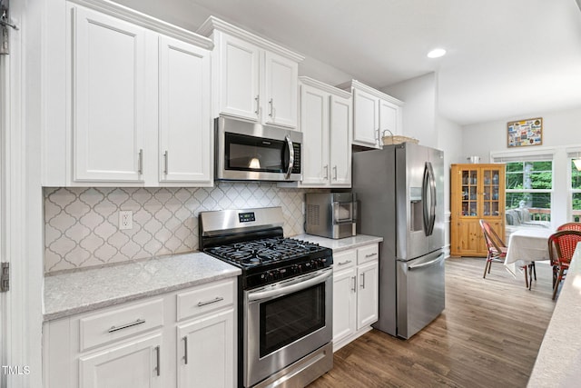 121 Roundrock Ln, Sanford, NC 27330 - kitchen with stainless steel appliances, white cabinetry, dark wood finished floors, backsplash, and recessed lighting
