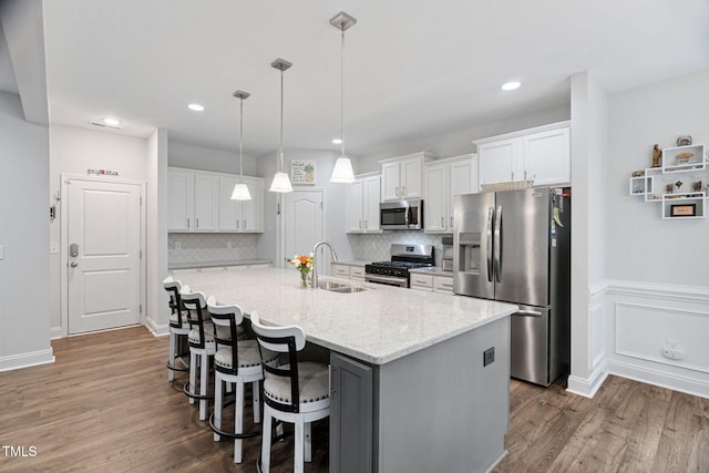 121 Roundrock Ln, Sanford, NC 27330 - kitchen with stainless steel appliances, dark wood-style floors, white cabinetry, a kitchen island with sink, and recessed lighting