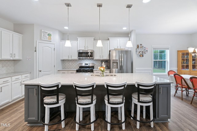 121 Roundrock Ln, Sanford, NC 27330 - kitchen with appliances with stainless steel finishes, a spacious island, dark wood-style floors, tasteful backsplash, and recessed lighting
