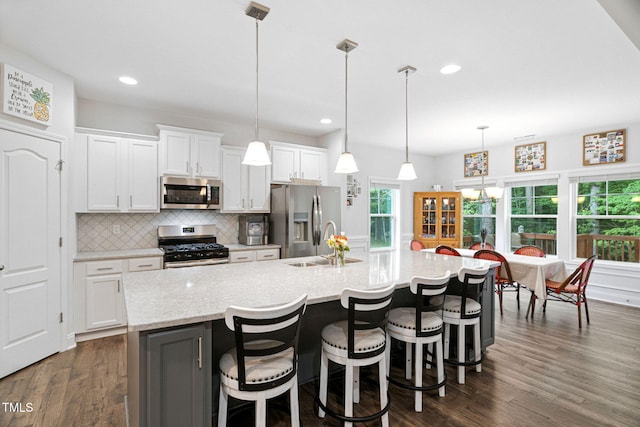 121 Roundrock Ln, Sanford, NC 27330 - kitchen featuring stainless steel appliances, tasteful backsplash, a large island, white cabinetry, and dark wood finished floors