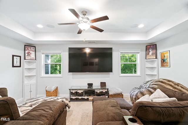 121 Roundrock Ln, Sanford, NC 27330 - carpeted living room featuring a raised ceiling, healthy amount of natural light, and ceiling fan