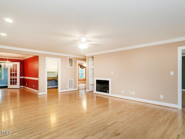 6843 Sawyer Rd, Liberty, NC 27298 - unfurnished living room featuring a chandelier, light wood-type flooring, crown molding, a fireplace, and a ceiling fan
