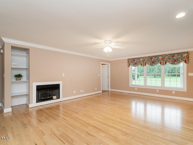 6843 Sawyer Rd, Liberty, NC 27298 - unfurnished living room featuring a fireplace, light wood-type flooring, ceiling fan, ornamental molding, and built in shelves