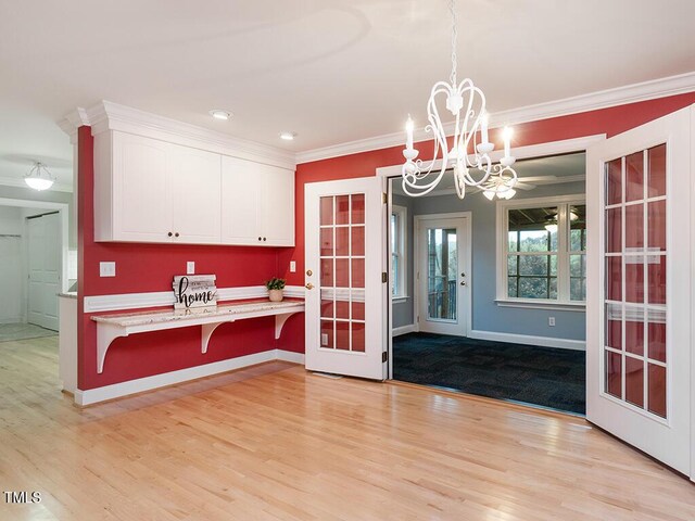 6843 Sawyer Rd, Liberty, NC 27298 - kitchen featuring white cabinetry, a chandelier, light countertops, light wood-type flooring, and ornamental molding