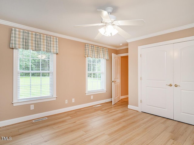 6843 Sawyer Rd, Liberty, NC 27298 - unfurnished bedroom featuring light wood finished floors, crown molding, a closet, and a ceiling fan